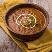 Dal Makhani · Whole black lentils cooked in gingers, garlic, onions, and some herbs in butter sauce.