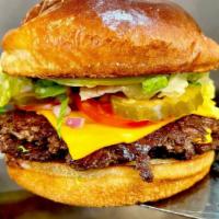 Smash Burger · 4oz Angus beef Pattie, American cheese, garlic aioli, tomato’s, shredded lettuce on a Brioch...