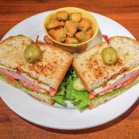 Bistro Club Sandwich · Turkey pastrami, maple-peppered bacon, Swiss cheese, lettuce, tomato, pickle, spicy mustard ...