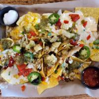 Chicken Nachos · Chicken, queso, cheddar jack & Cotija cheeses, fire roasted red peppers, onion & cilantro, j...