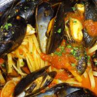 Zuppa di Mussels · Served with marinara sauce or garlic-white wine and fresh herbs over linguine.