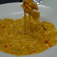 Farfalle Quattro Formaggi · Bowtie pasta in pink sauce with 4 different cheeses.