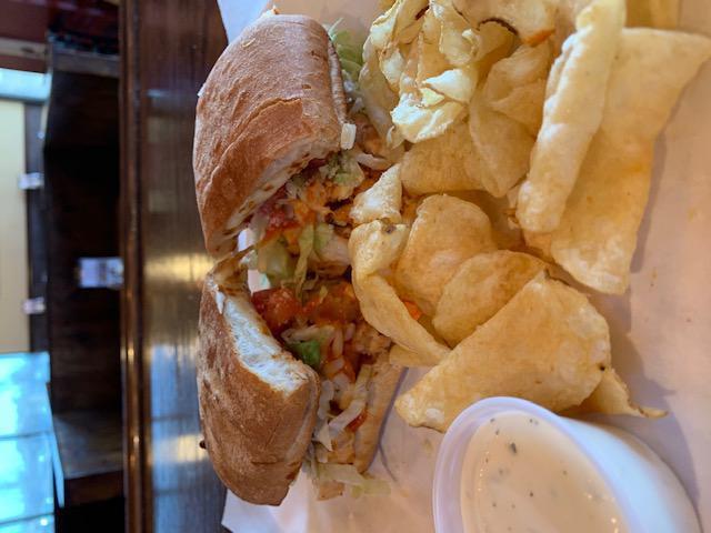 Buffalo Chick Town · Grilled chicken with our savory Buffalo sauce, mozzarella, Parmesan, lettuce and tomato, served with a side of ranch.
