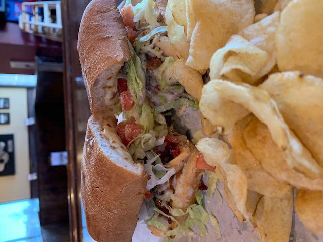 Cluck Norris · Grilled chicken, bacon, lettuce, tomato, mozzarella, Parmesan and Italian dressing.