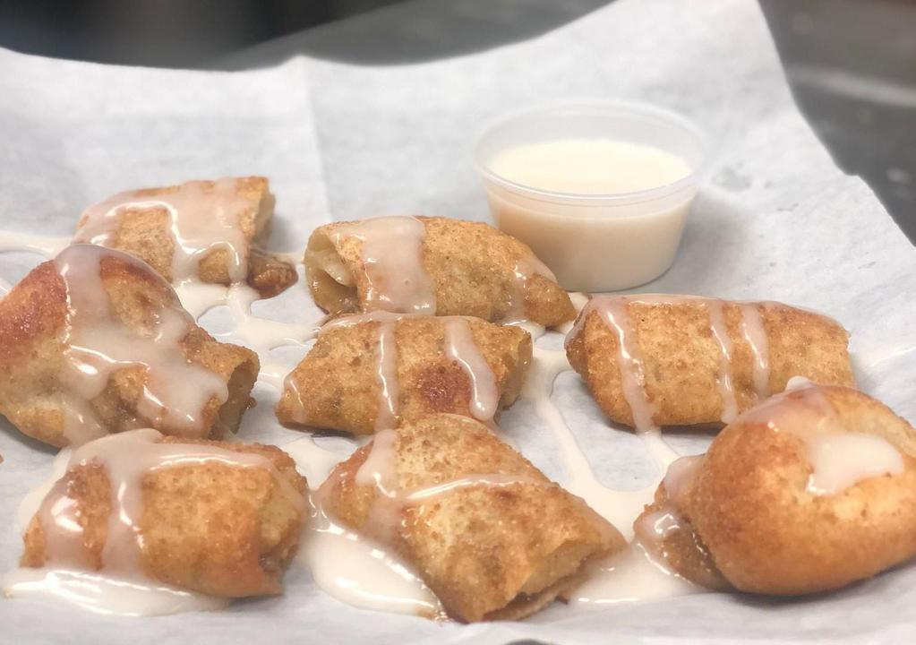 Cinna-bites · Our homemade dough, lightly spread cream cheese, sprinkled with cinnamon and sugar and baked to perfection, served with ziggy's icing.