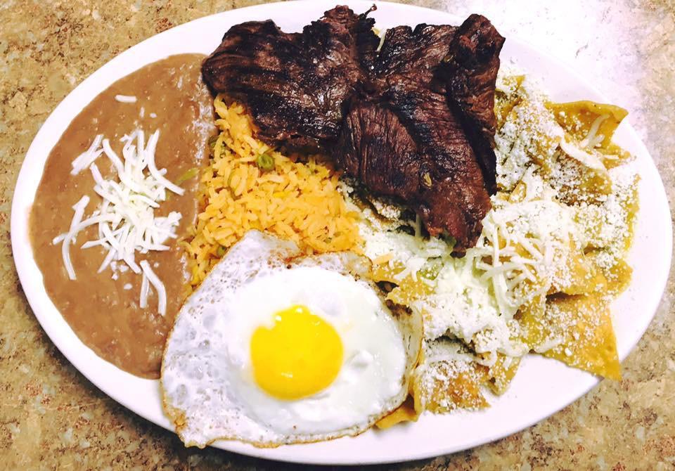 Chilaquiles con Huevo y Carne · Tortilla corn chips simmered, red or green sauce with two eggs and steak.