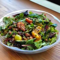 Green Quinoa Salad · Lemony rocket greens and energy greens, quinoa, chickpeas, grape tomatoes, cranberries, rais...