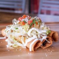 Flautas · rolled crispy chicken tacos, pinto beans, lettuce, cotija cheese, crema, pico de gallo