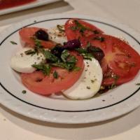 Caprese Salad · Tomatoes, fresh mozzarella, Kalamata olives and basil. Fresh hot home-made bread.