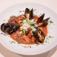 Cioppino · Mussels, clams, scallops, prawns, salmon, calamari and crab with fresh tomatoes in a white w...