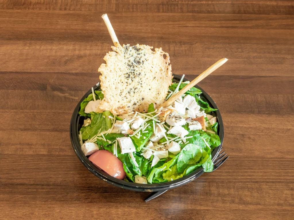 Italian Chopped Salad · Italian chopped salad with chicken, pasta, tomatoes, smoked bacon, sunflower seeds, Parmesan cheese, red onion, Gorgonzola, and croutons tossed in an Italian vinaigrette.