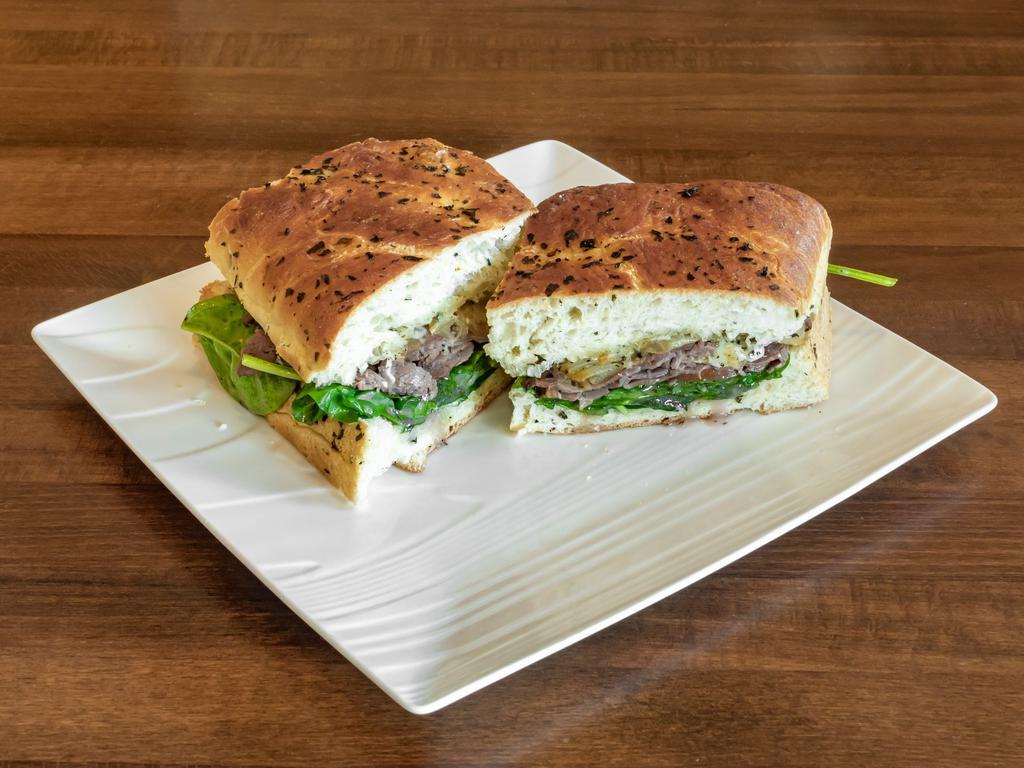 Roast Beef Focaccia · Roast beef with Gorgonzola, roasted onions, tomato, and forest greens tossed in Cabernet vinaigrette.
