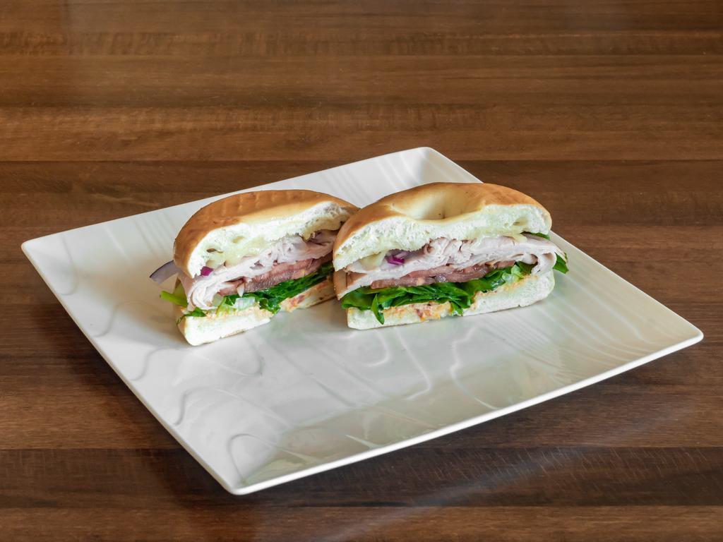 Turkey Bagel · Smoked turkey with provolone cheese, tomato, red onion, forest greens, and sun-dried tomato cream cheese.