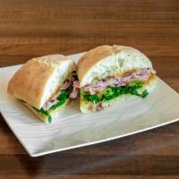 Ham Ciabatta · Smoked ham, salami, prosciutto with tomato, roasted onions, forest greens, cheddar cheese, S...
