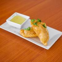 Empanadas · Fried flour pastry with a filling choice of beef or chicken.

