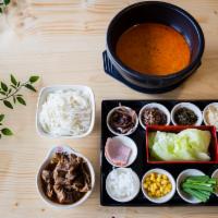 R12. Spicy Beef Brisket Rice Noodles 麻辣牛腩米线 · Spicy soup base with beef brisket, rice noodles, and many small side dishes