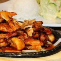 Spicy Chicken with Mushrooms · Grilled chicken sautéed with hot sauce and mushrooms. Comes with steamed rice, salad, and tr...