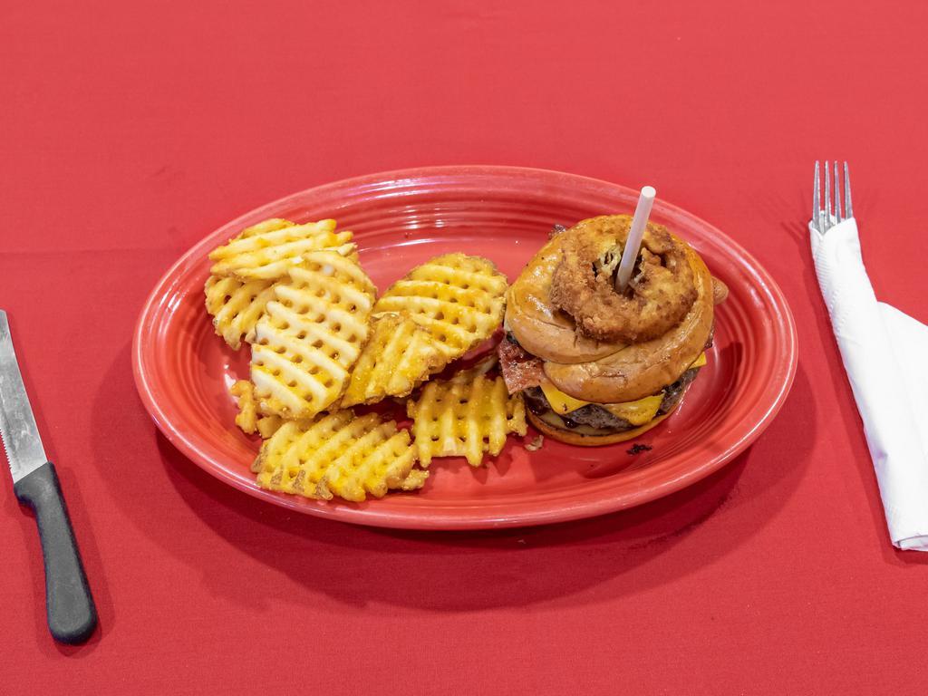 Cowboy Angus Burger · Crispy crumbled applewood smoked bacon, cheddar cheese, onion rings and smokey BBQ sauce.