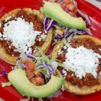 Sopes 2 · Thick tortillas with raised edges topped with refried beans, meat of your choice, fresh whit...