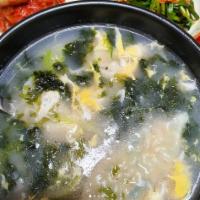 Sliced Rice Cake Soup with Dumplings 떡만두국 · Savory soup with dumplings. 