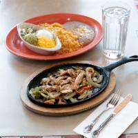 Fajitas · Marinated in our secret sauce, then delivered sizzling hot over a bed of sauteed
onions and ...