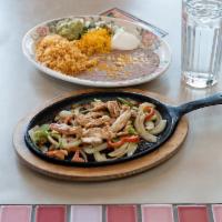 Fajitas for 2 · Served with rice, choice of pinto or black beans, pico de gallo, cheese, lettuce, sour
cream...