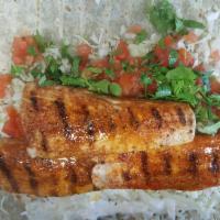 Fish Burrito Grilled Mahi  · Comes with Grilled Mahi  ,rice , cabbage , cilantro , tomatoes, white Baja cream and Chipotl...