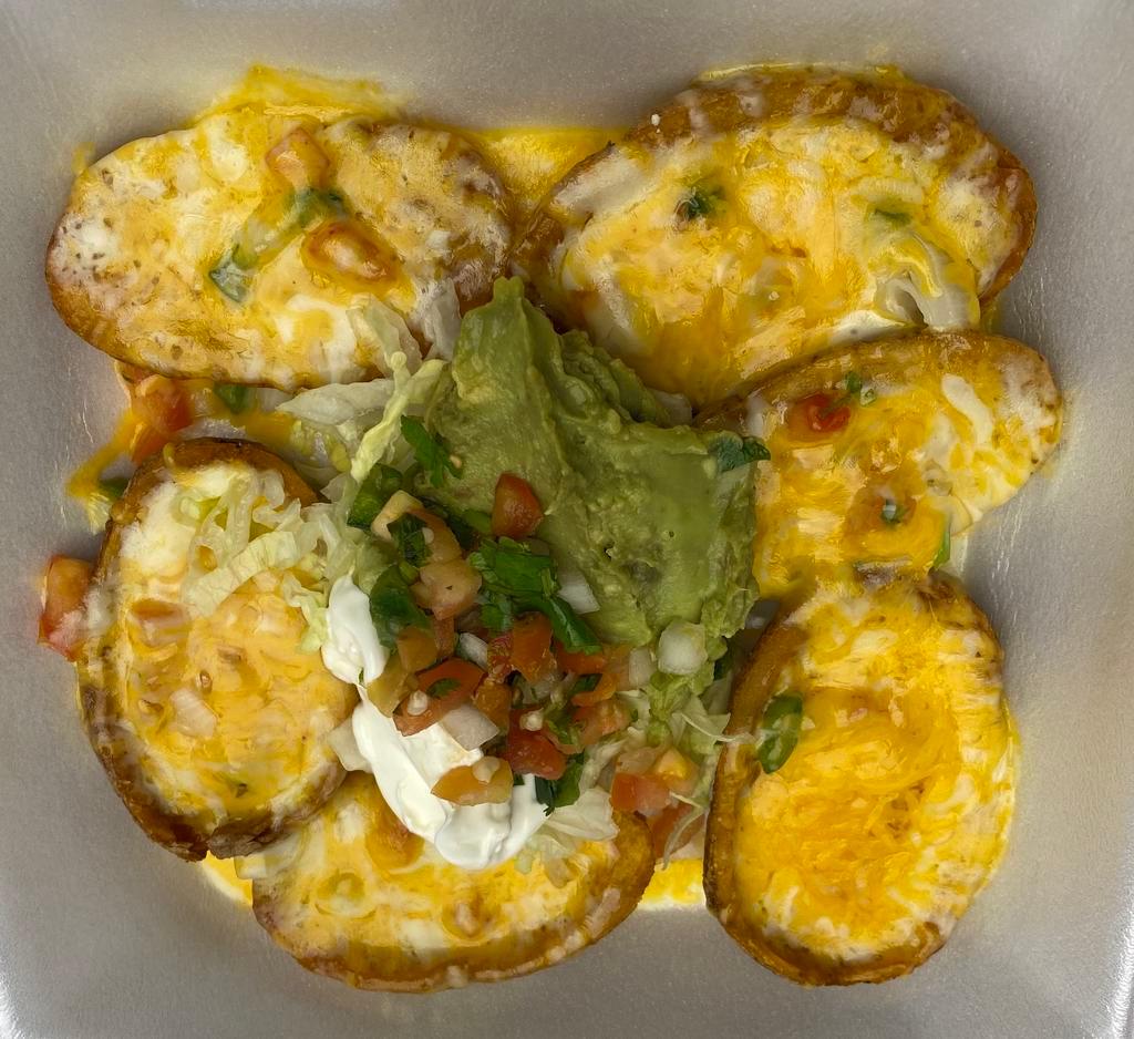 Idaho Potatoes · Crispy potato skin filled with tasty ground beef and topped with melted cheese. Garnished with guacamole and sour cream.