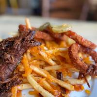 Pulled Pork Fries · Shoestring fries, pulled pork, BBQ sauce, cheddar cheese, onion and dill pickles