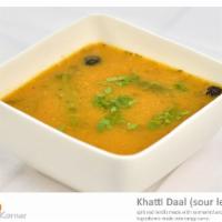 Khatti Daal (Sour Lentils) · Split red lentils made with tarmarind and other rich ingredients made into tangy curry.