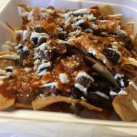 NACHOS · FRESHLY MADE CHIPS, REFRIED BEANS, CHOICE OF MEAT, SOUR CREAM, COTIJA CHEESE & PICO DE GALLO