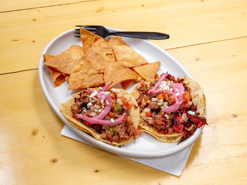 Brisket Taco Plate · 3 Grilled Brisket tacos topped with Pico de gallo, jalapeño salsa, pickled red onions, shredded cheese on corn tortillas. Served with chips.