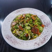 Fattoush Salad · Lettuce, tomato, cucumber, pita chips, onions, and Mediterranean spices. 