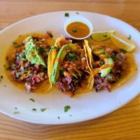Brisket Tacos (3) · Our famous Brisket, topped with an avocado slice, pico de gallo, and our house piripiri sauc...