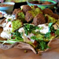 Falafel Full Salad · Our famous falafel served on top of lettuce, tomatoes, onions, pickles, parsley and dressed ...