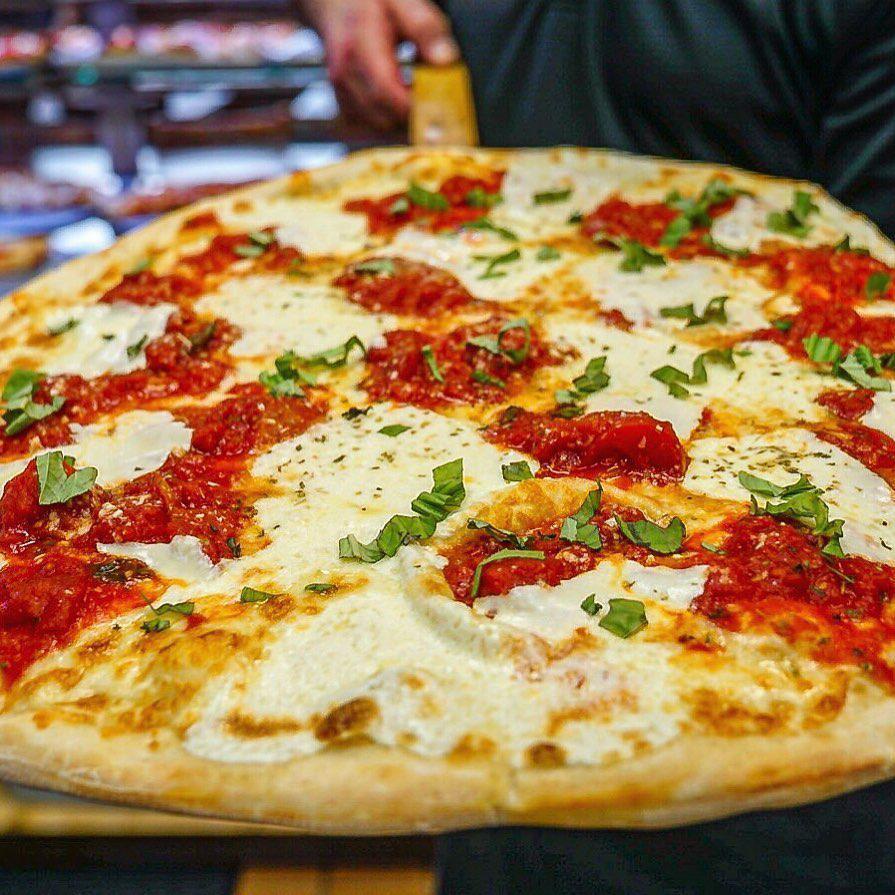 Margherita Pizza · Traditional neapolitan pizza with fresh mozzarella, garlic, plum tomato sauce and imported extra virgin olive oil and fresh basil.