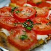 Fresh Mozzarella Tomato Pizza · Homemade mozzarella with fresh tomatoes topped with fresh garlic, basil and imported olive o...