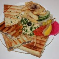 Toshka With Fries · Pita Bread Stuffed With Meet Mixed With Cheese And Spices, Served Hummus, Steak Fries And Sa...