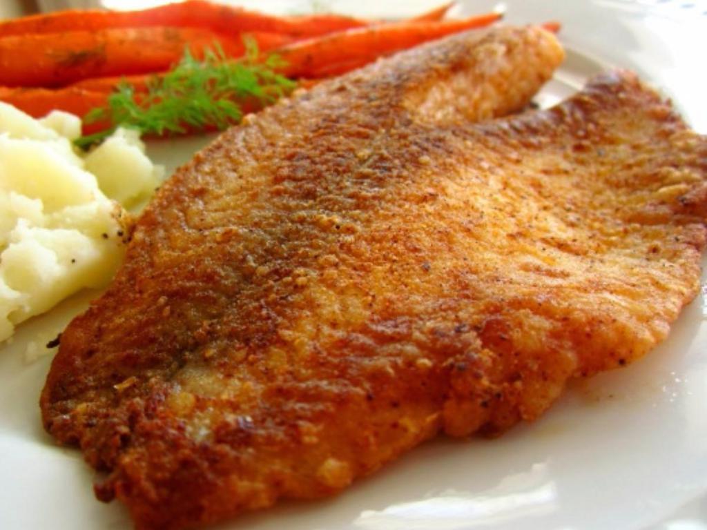 Tilapia Fillet · 2 fillet seasoned with spices, served on rice, with lemon and pickles.