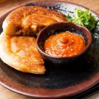 Ho' Cake · Crispy bun filled with heavenly pork belly served with kimchi hot sauce.