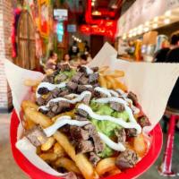 CARNE ASADA FRIES · FLAMED GRILLED ANGUS STEAK (100% CERTIFIED ANGUS BEEF), FRIES, GUACAMOLE, SOUR CREAM & CHEESE