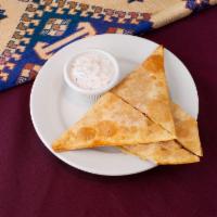 Sambosa · Fried dumplings filled with seasoned ground beef, herbs and spices.