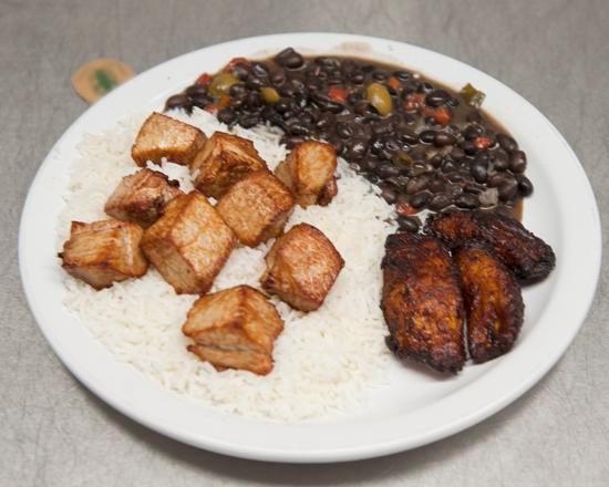 Massitas De Puerco · Pork cubes marinated in mojo and deep fried. Served with maduros, white rice and black beans. All paper packaging.