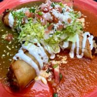 Flautas · Two crispy corn tortillas, each cut in half and filled with chicken, potato, and queso fresc...