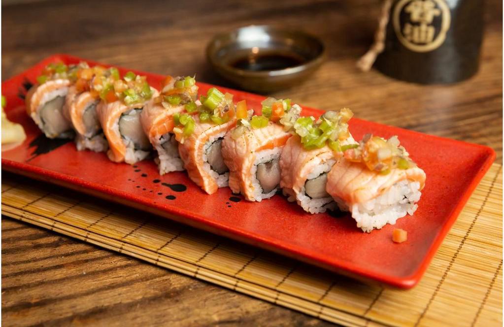 Aburi Salmon Roll · Seared salmon on yellowtail and jalapeno roll with wasabi salsa.