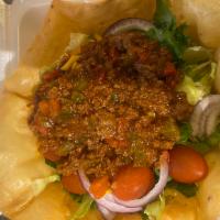 Taco Salad · A taco shell with seasoned ground beef or chicken, red onions, lettuce, tomatoes, black oliv...