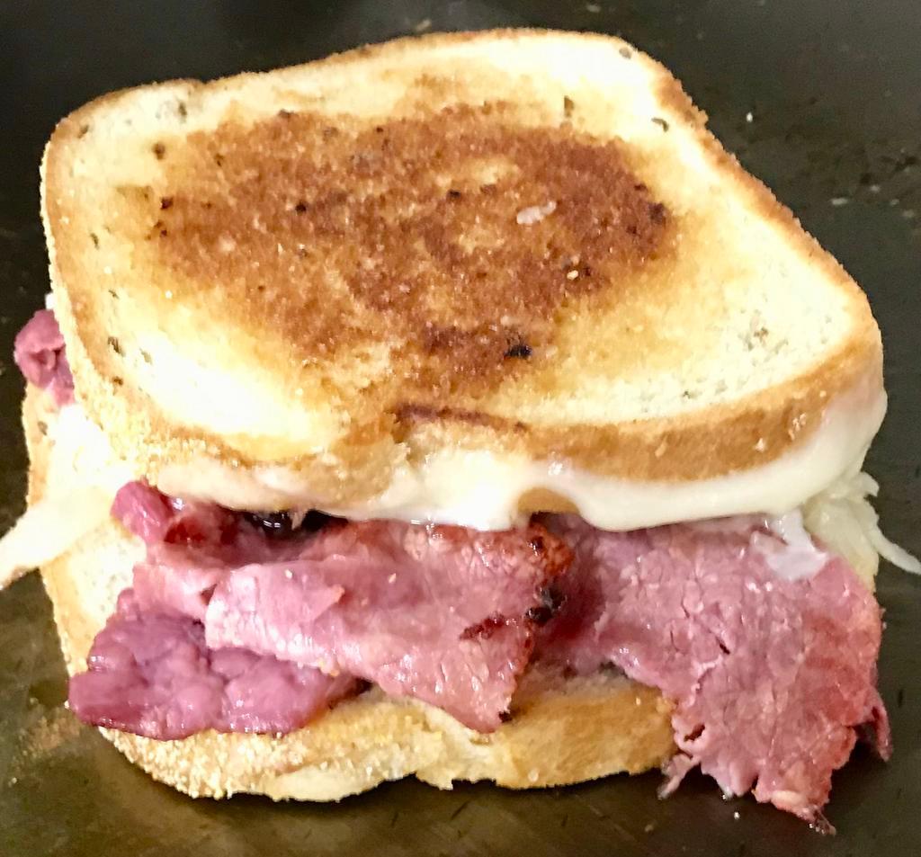 Reuben Sandwich · Turkey or pastrami, Swiss cheese, and sauerkraut on grilled rye. Served with Thousand Island dressing on the side.