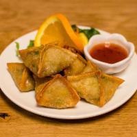 Vegetarian Samosa · Delicately stuffed and fried with mildly spiced potatoes and peas.