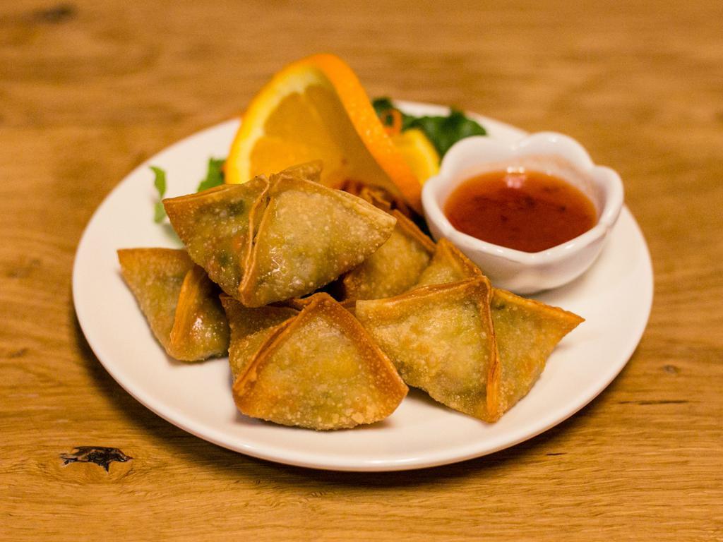 A5. Green Curry Puffs · Fried wonton stuffed with chicken, potatoes, carrots and green curry paste. Served with sweet and sour sauce.