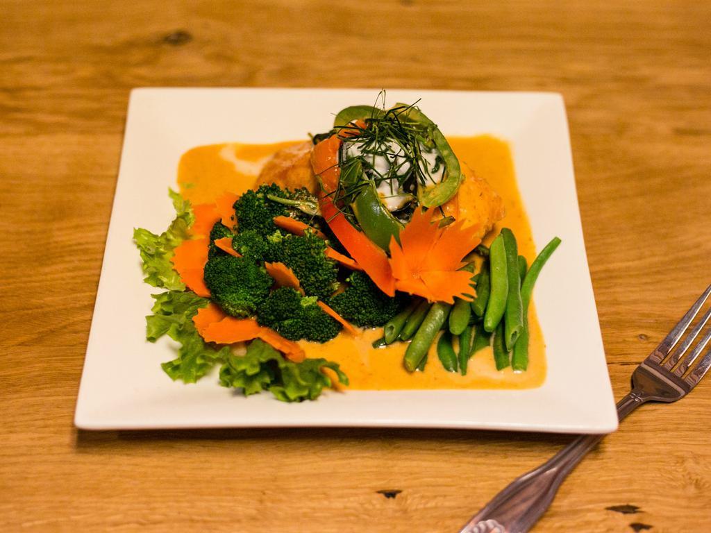 SP4. Pa-nang Salmon · Grilled salmon topped with a homemade pa-nang curry sauce, bell peppers and sweet basil.